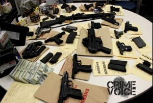 Police display the guns found at the Cuevas' home