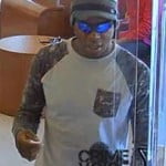 Robber leaves the bank with cash