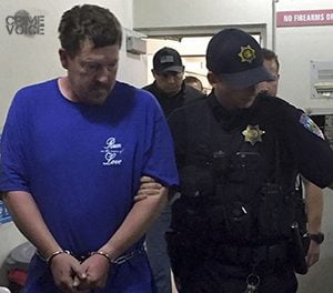 McCann in custody. His shirt says, "Run in the name of love"