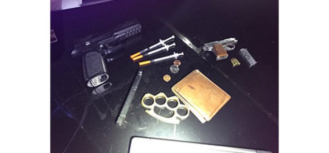 Man drives with drugs, gun, metal knuckles