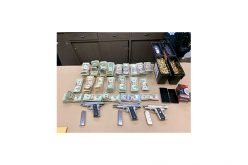 Three guns, drugs and cash seized in search warrant service