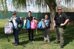 TCSO Deputy accepts backpacks for foster kids in transition