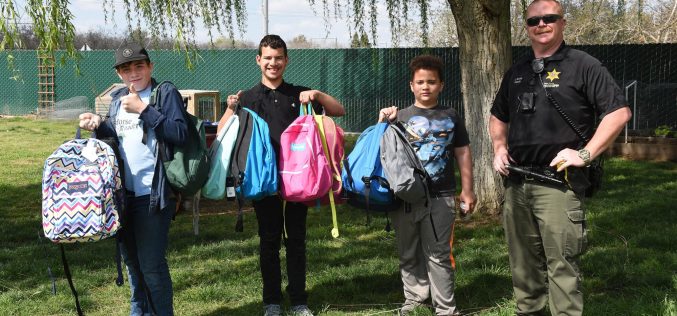 TCSO Deputy accepts backpacks for foster kids in transition