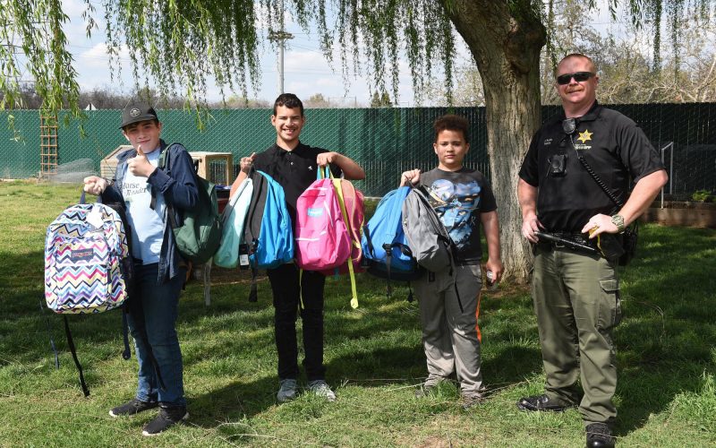 TCSO Deputy accepts backpacks for foster kids in transition