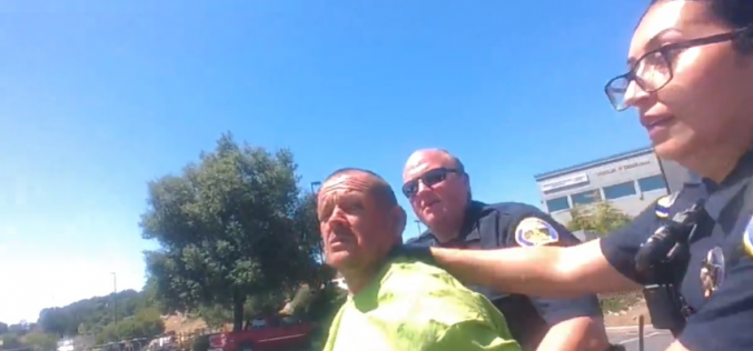 Lying down in a planter box, not wanting to be arrested