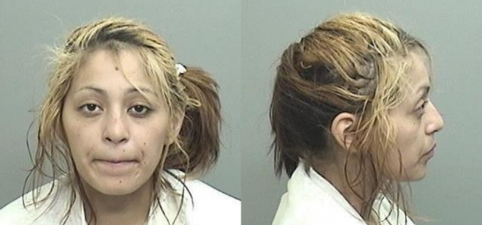 Woman slumped over in her car, under the influence