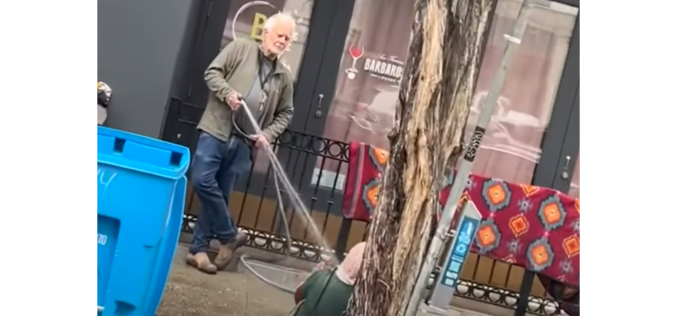 Art Gallery Owner Charged with Battery for Spraying Unhoused Woman with Hose